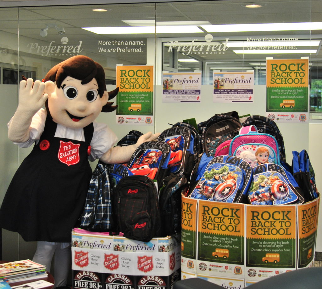 Sally from Salvation Army London Centre of Hope at Preferred Insurance with huge collection of backpacks & school supplies Rock Back to School Best First Day